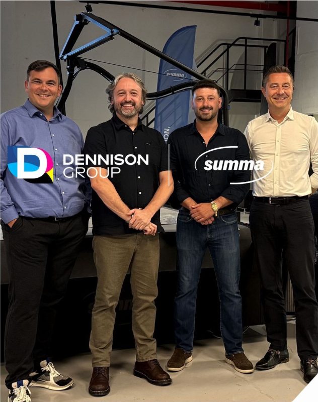 The Dennison Group and Summa teams together at Summa, in front of a Summa flatbed cutter